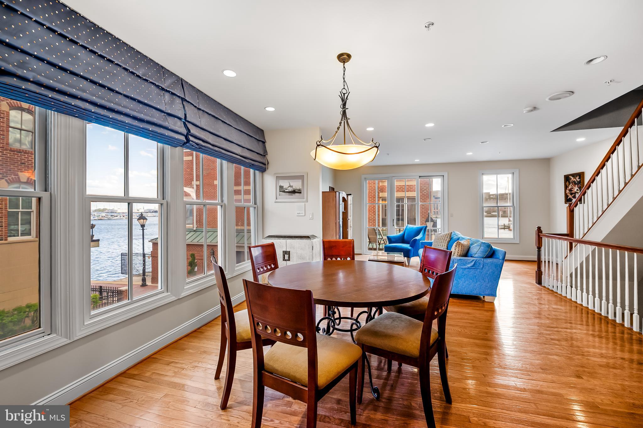 2323 Boston Street, Unit 6 Baltimore, MD 21224 - Photo 3 of 47 a view of a dining room with furniture window and wooden floor