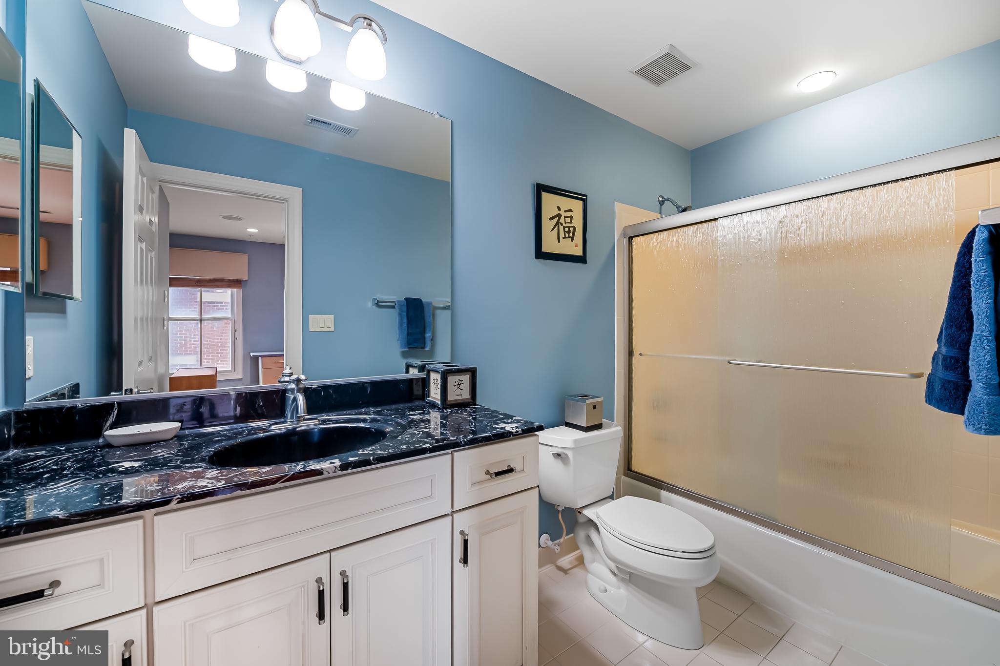2323 Boston Street, Unit 6 Baltimore, MD 21224 - Photo 32 of 47 a bathroom with a granite countertop sink toilet and shower