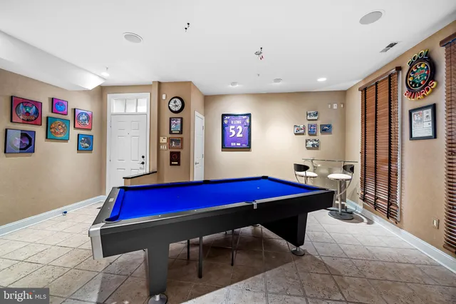 a room with pool table and windows