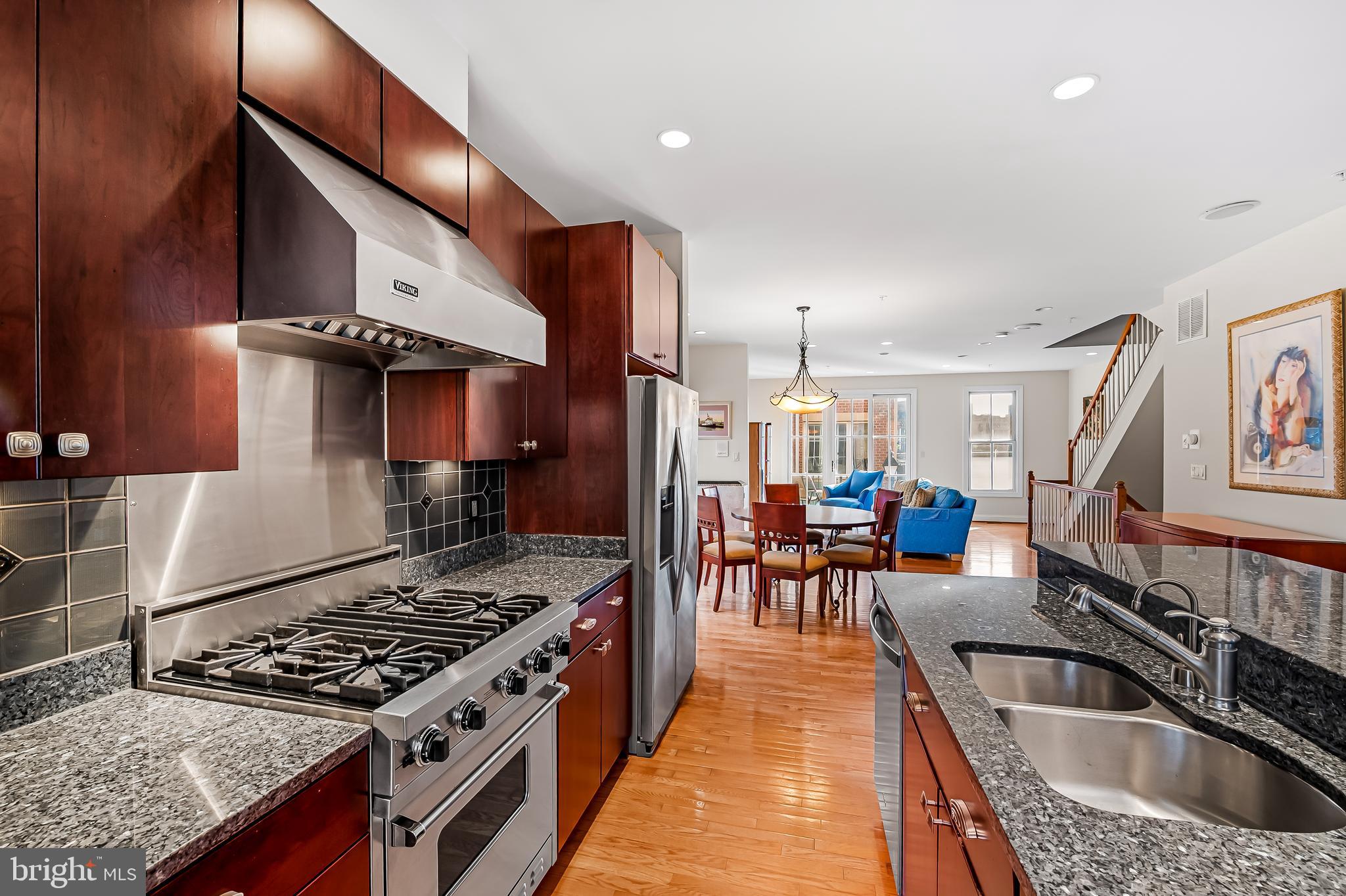 2323 Boston Street, Unit 6 Baltimore, MD 21224 - Photo 5 of 47 a kitchen with stainless steel appliances granite countertop a stove and a sink