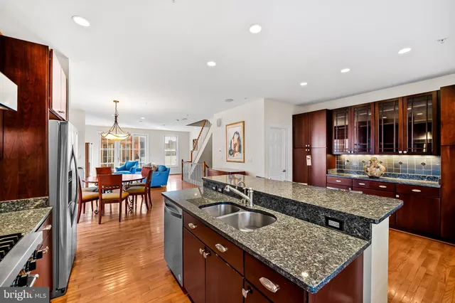 a kitchen with stainless steel appliances granite countertop a stove sink and cabinets