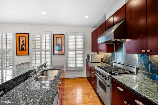 a kitchen with granite countertop lots of counter top space and stainless steel appliances