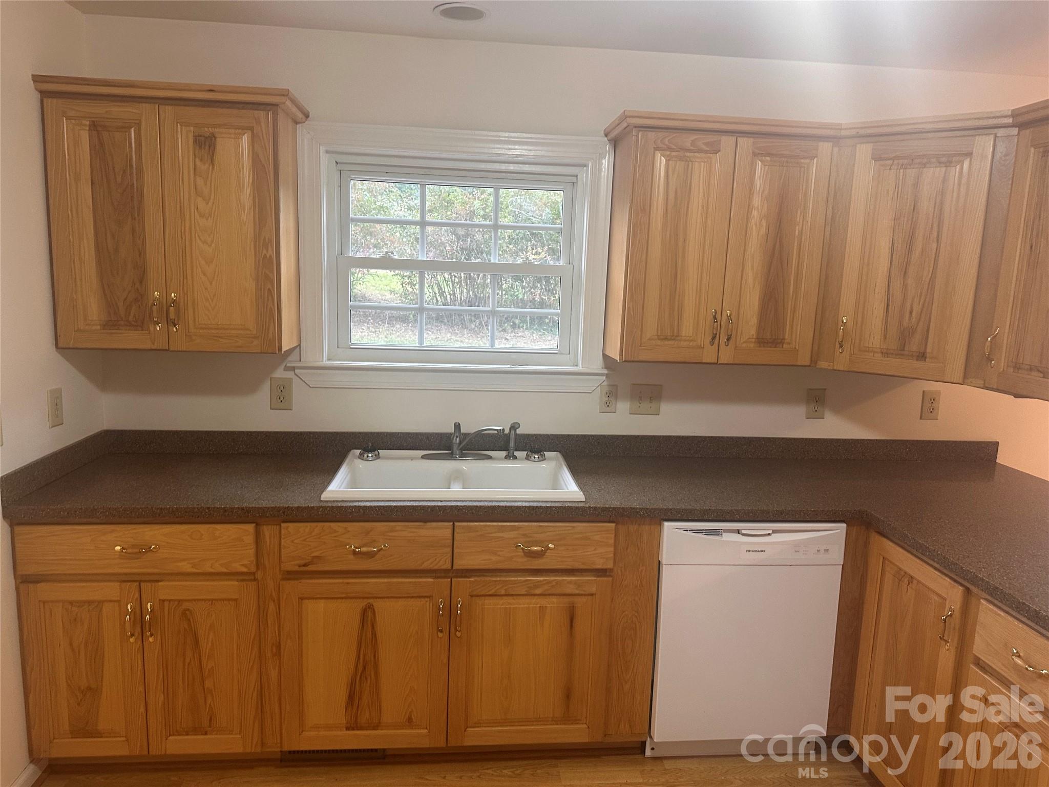 12087 Traphill Road Traphill, NC 28685 - Photo 17 of 40 a kitchen with white cabinets and sink