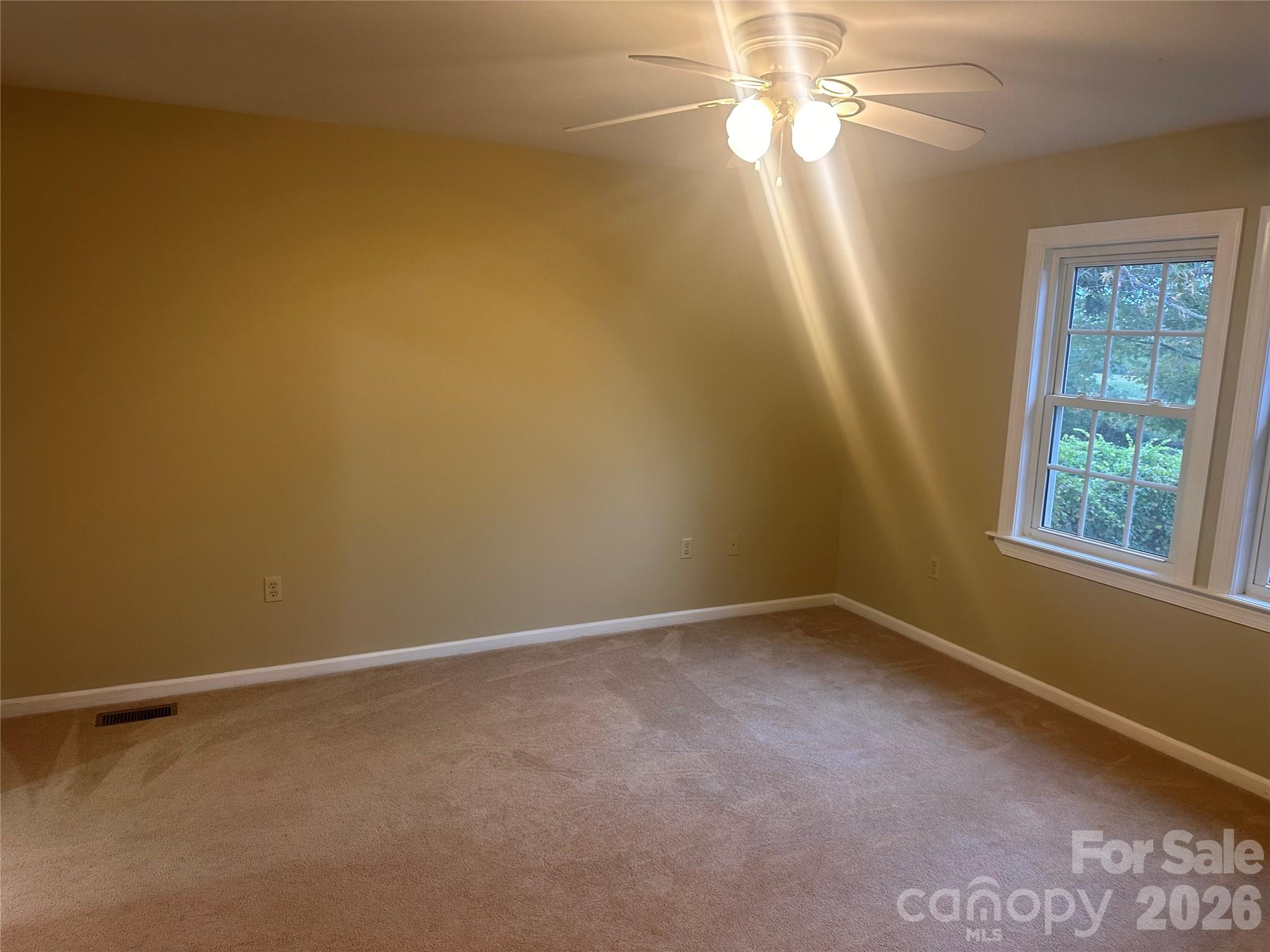 12087 Traphill Road Traphill, NC 28685 - Photo 22 of 40 an empty room with windows and fan