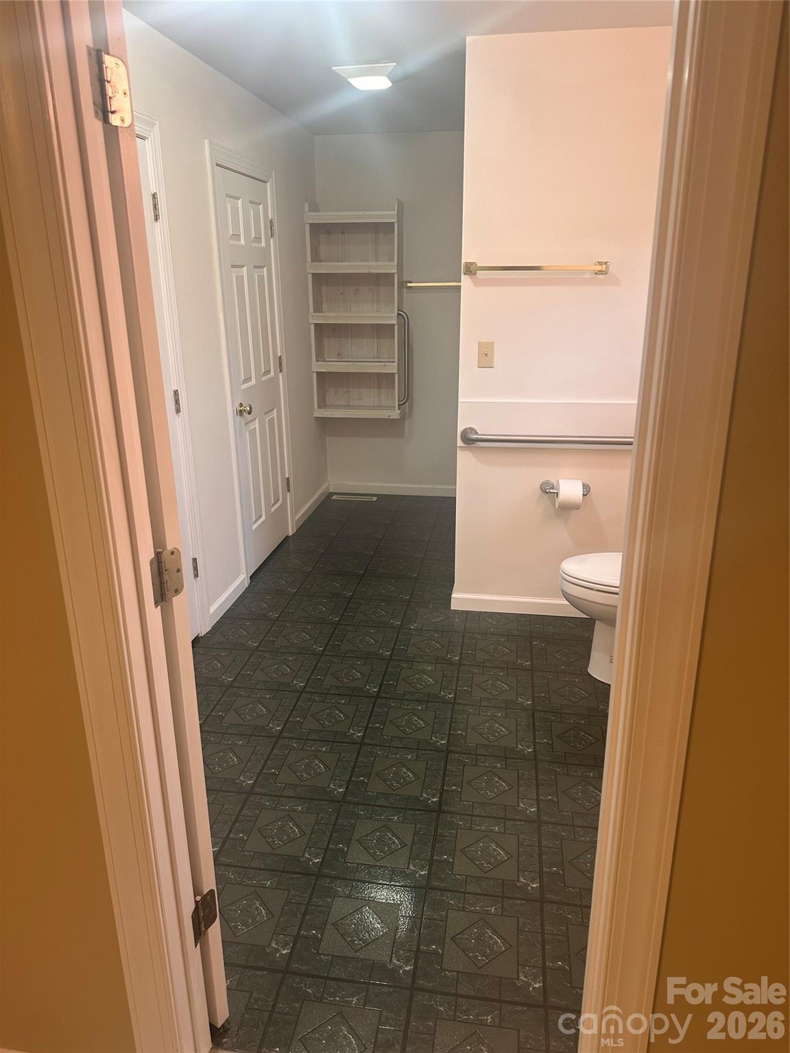 12087 Traphill Road Traphill, NC 28685 - Photo 23 of 40 a bathroom with a granite countertop shower and a toilet