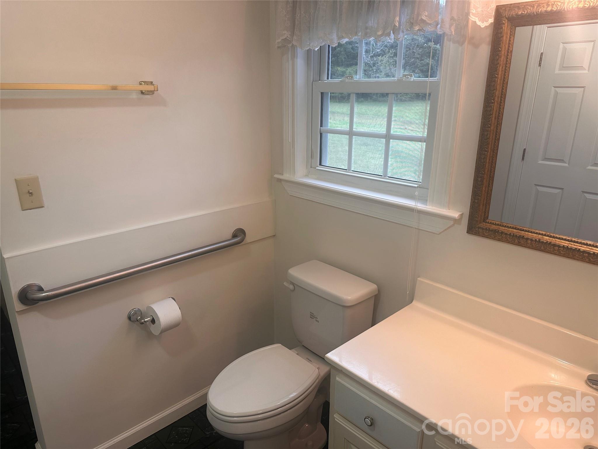 12087 Traphill Road Traphill, NC 28685 - Photo 24 of 40 a bathroom with a toilet a sink and a window
