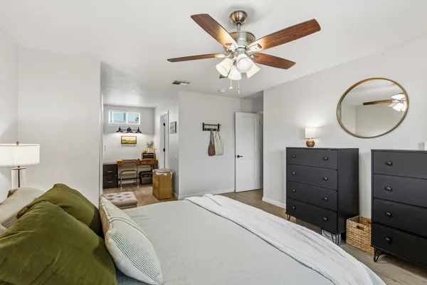 a bedroom with a bed and wooden floor