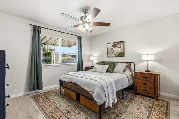 a bedroom with a large bed and a window