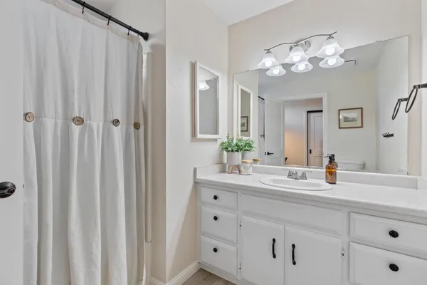 a bathroom with a double vanity sink and a mirror