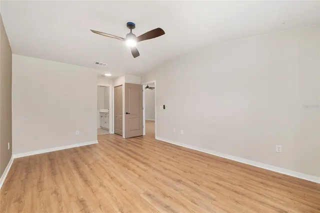 a spacious bathroom with a toilet sink and mirror