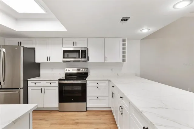 a kitchen with a sink stove and refrigerator