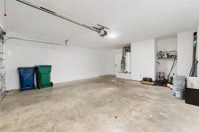 a view of a yard with plants and trees