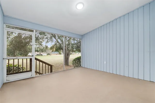 a view of a yard with plants and trees