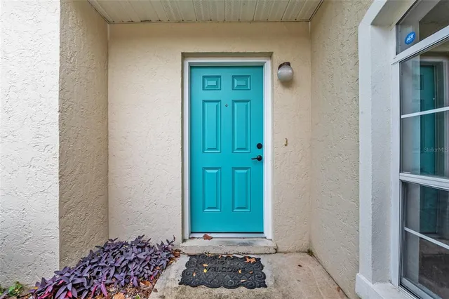 a view of a hallway with wooden floor and entryway