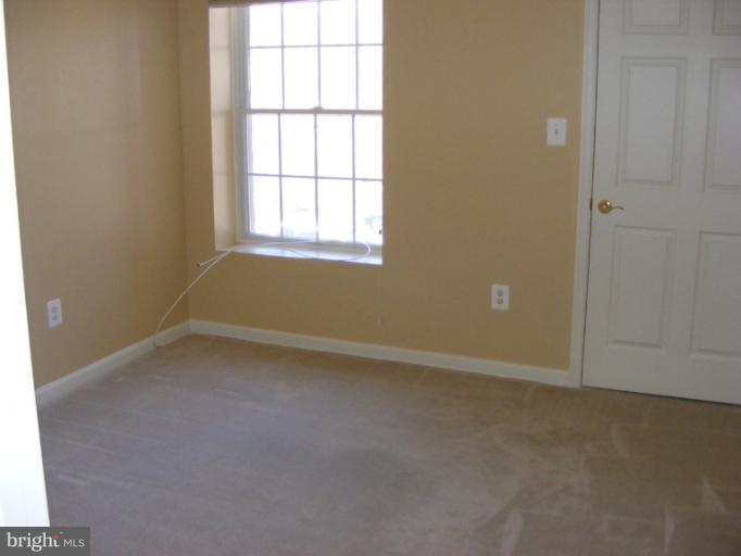 12000 Tralee Road, Unit 304 Lutherville-Timonium, MD 21093 - Photo 1 of 9 an empty room with a empty space and windows