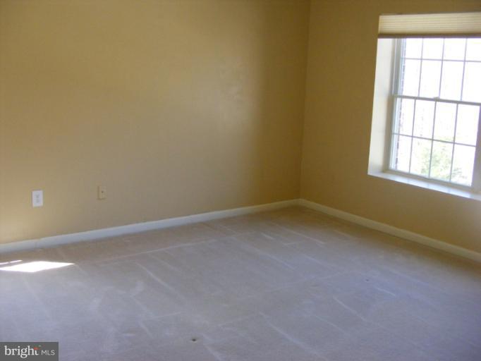 12000 Tralee Road, Unit 304 Lutherville-Timonium, MD 21093 - Photo 4 of 9 an empty room with a window