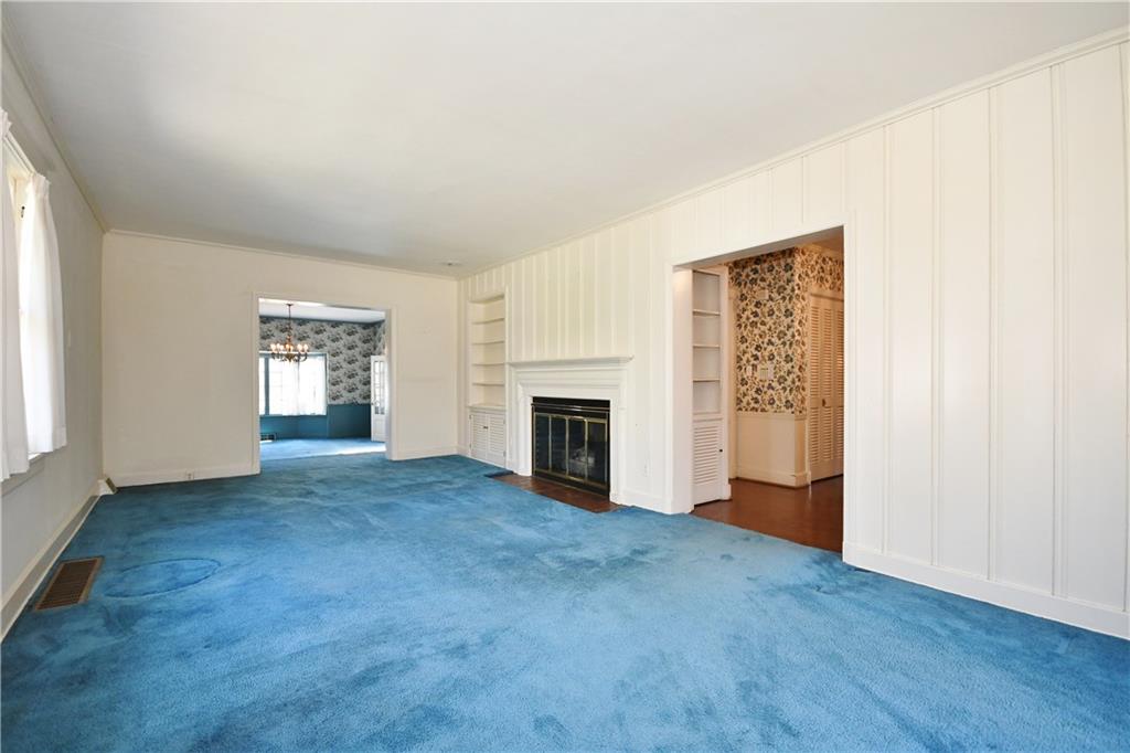 405 East Waldheim Road Pittsburgh, PA 15215 - Photo 4 of 25 Bright and spacious, panelled living room boasts fireplace and built-ins. Hardwood floors under carpet.
