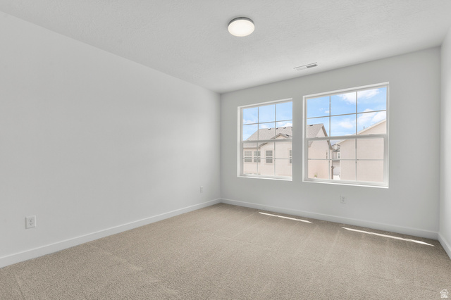 7797 West Alta Springs Way Magna, UT 84044 - Photo 14 of 21 Spare room featuring carpet flooring and baseboards