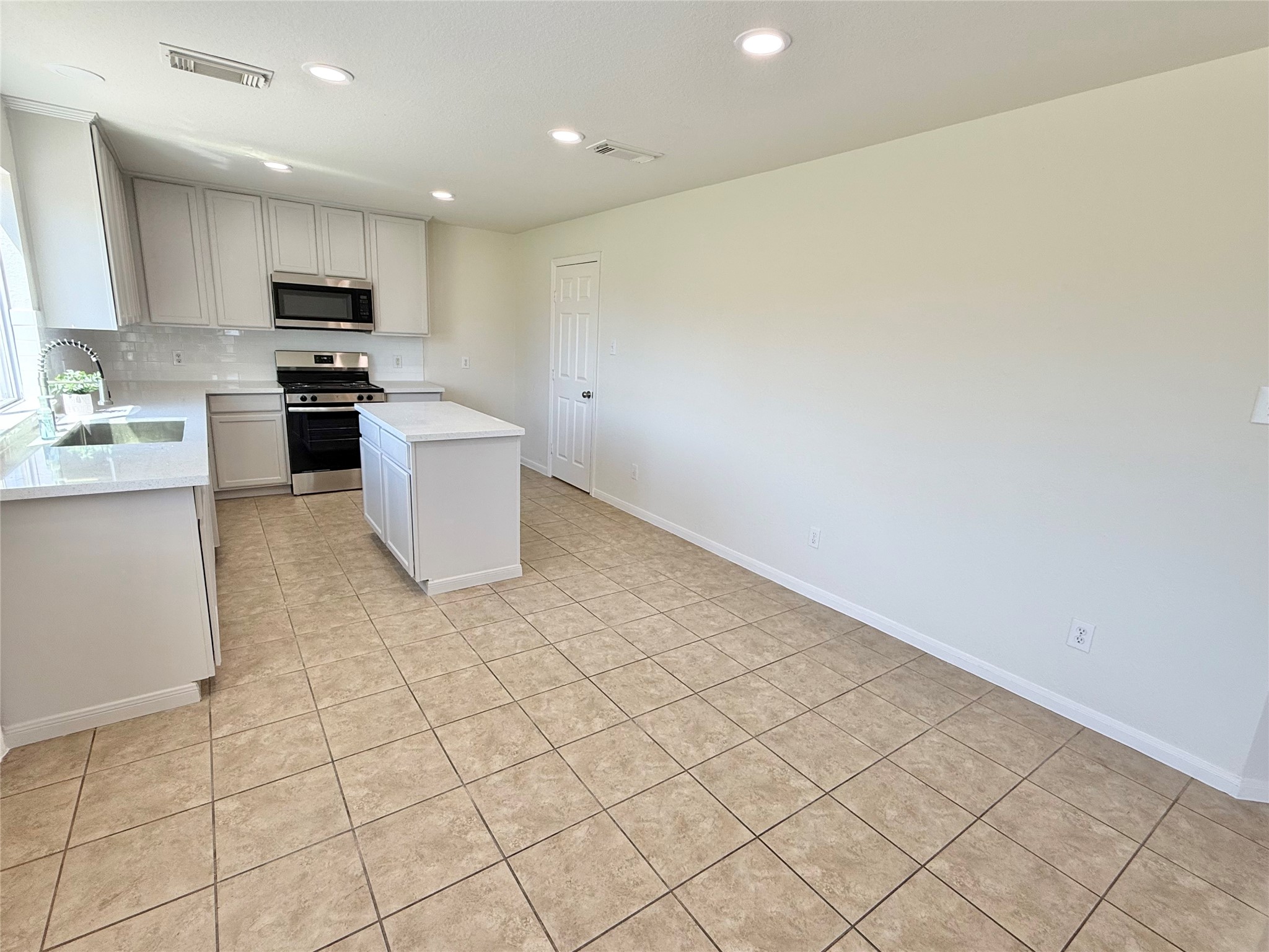 3430 Falcon Trail Court Spring, TX 77373 - Photo 7 of 31 Updated kitchen with new stainless steel appliances, including a brand new sink and faucet, dishwasher, oven/range and microwave, with access to a spacious walk-in pantry and utility room.