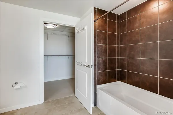 a bathroom with a tub and shower