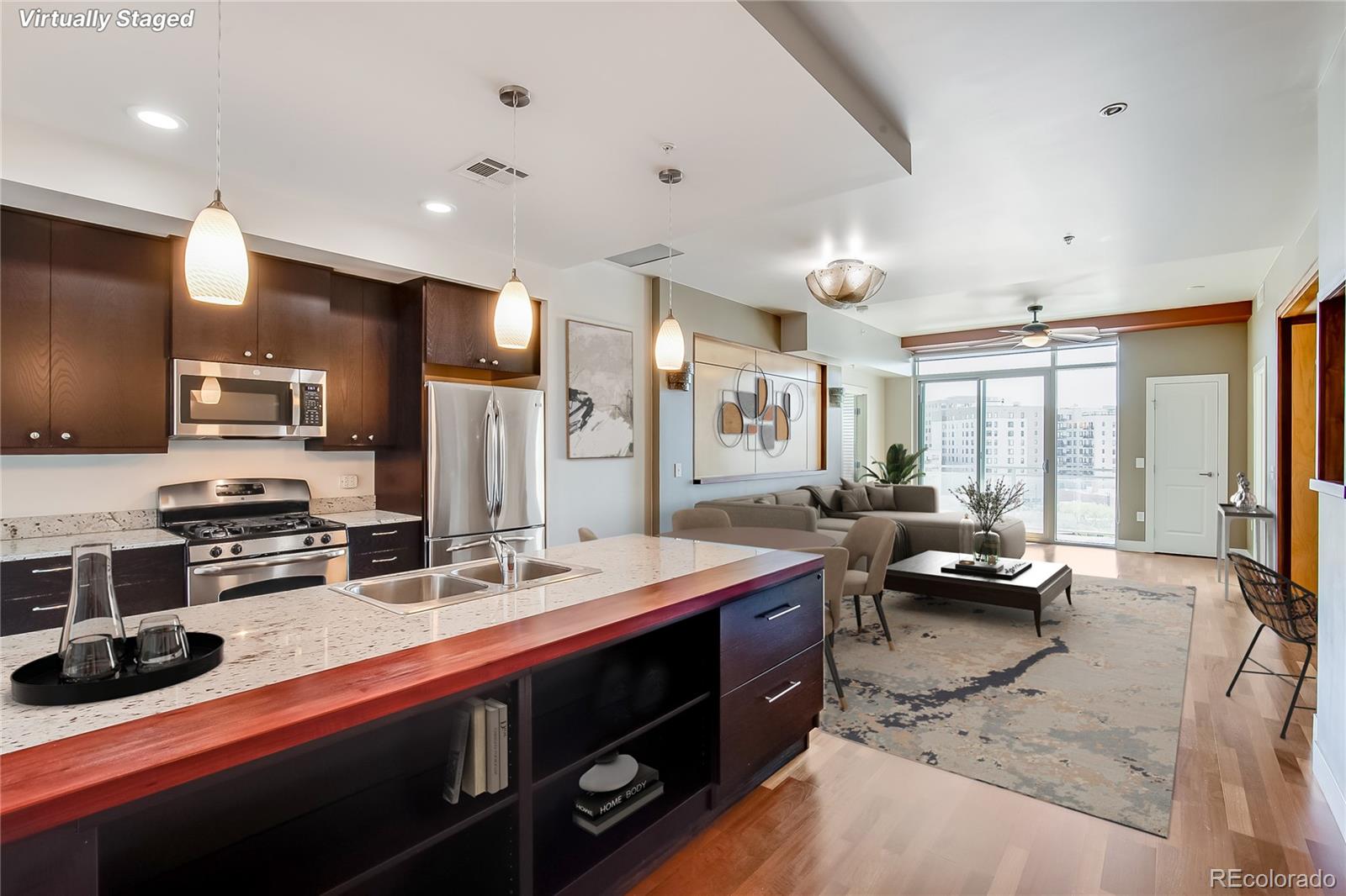 2001 Lincoln Street, Unit 1024 Denver, CO 80202 - Photo 2 of 19 a large kitchen with stainless steel appliances kitchen island granite countertop a sink and cabinets