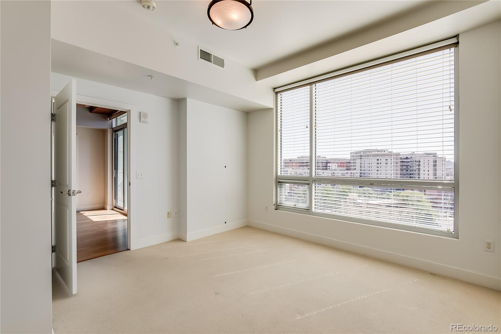 2001 Lincoln Street, Unit 1024 Denver, CO 80202 - Photo 6 of 19 a view of an empty room with a window