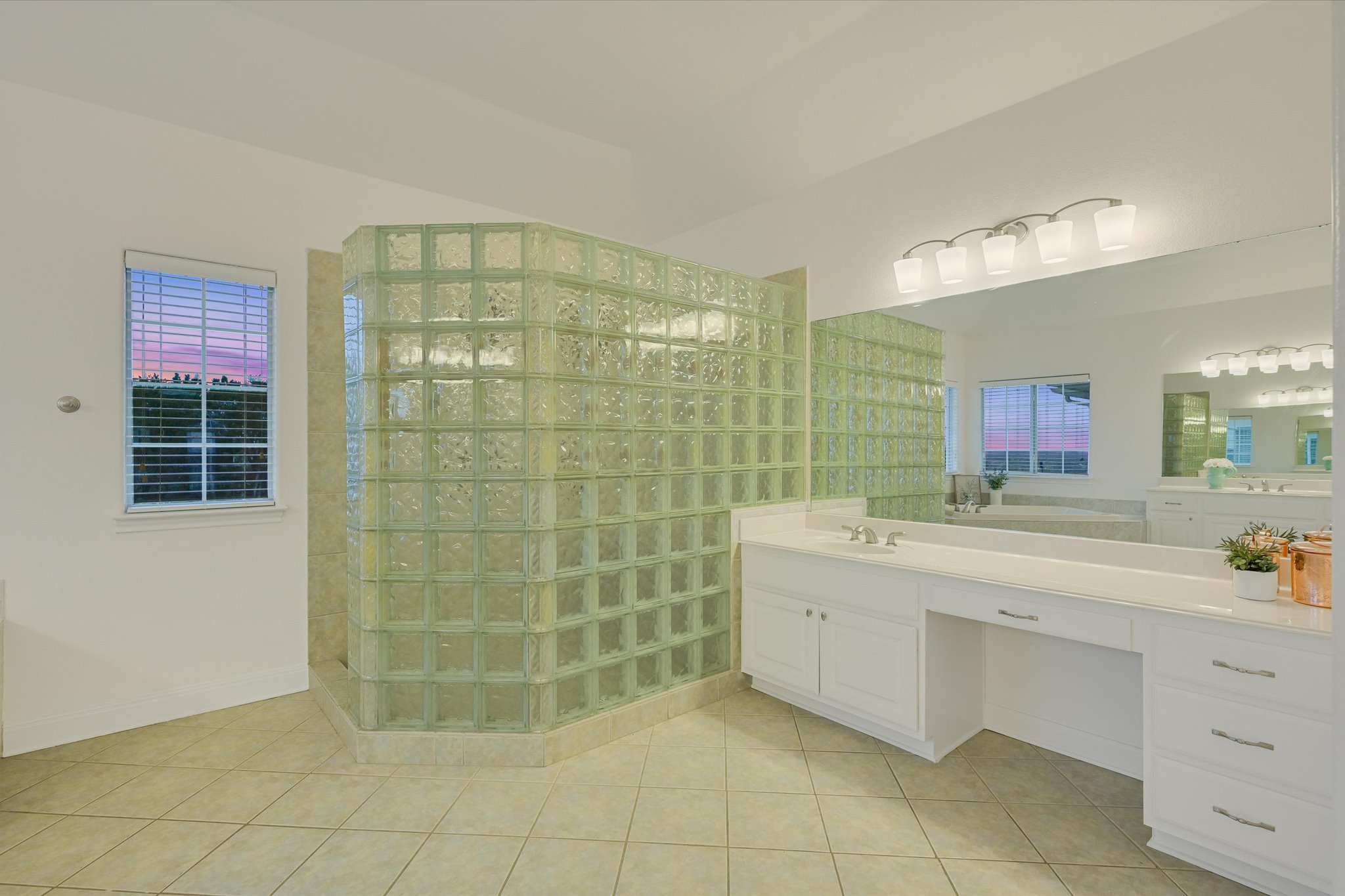 4319 Rum Runner Road Austin, TX 78734 - Photo 22 of 40 Bathroom with vanity, light tile patterned floors, walk in shower, and healthy amount of natural light