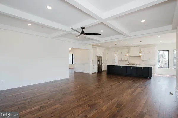 a kitchen with stainless steel appliances granite countertop white cabinets and a stove