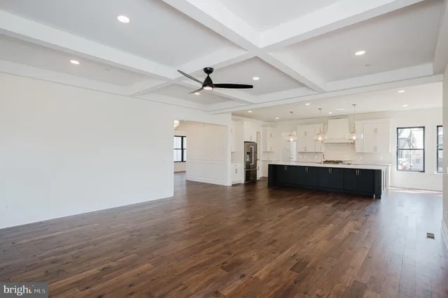 a kitchen with stainless steel appliances granite countertop white cabinets and a stove