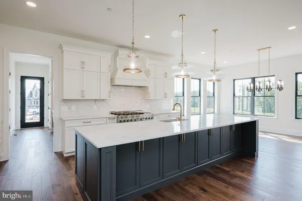 a kitchen with a sink a stove and cabinets