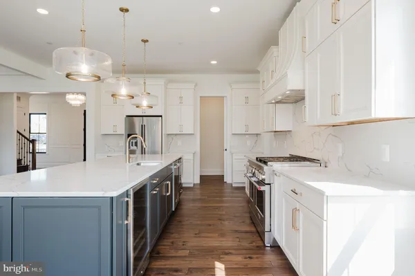 an empty room with wooden floor a ceiling fan and windows