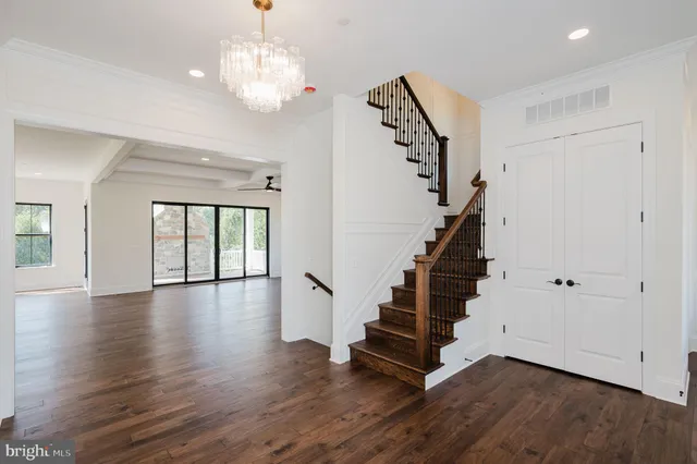 a view of an entryway with wooden floor and staircase