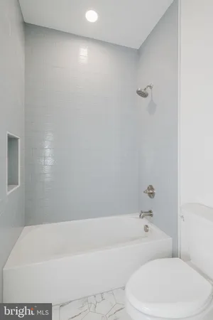 a view of a swimming pool with a yard and plants