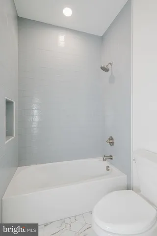 a view of a swimming pool with a yard and plants