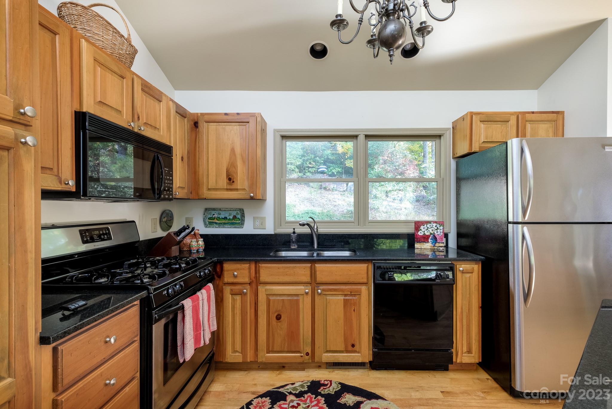 122 Columbine Way Cleveland, SC 29635 - Photo 11 of 28 a kitchen with granite countertop a sink stainless steel appliances a window and a counter top space