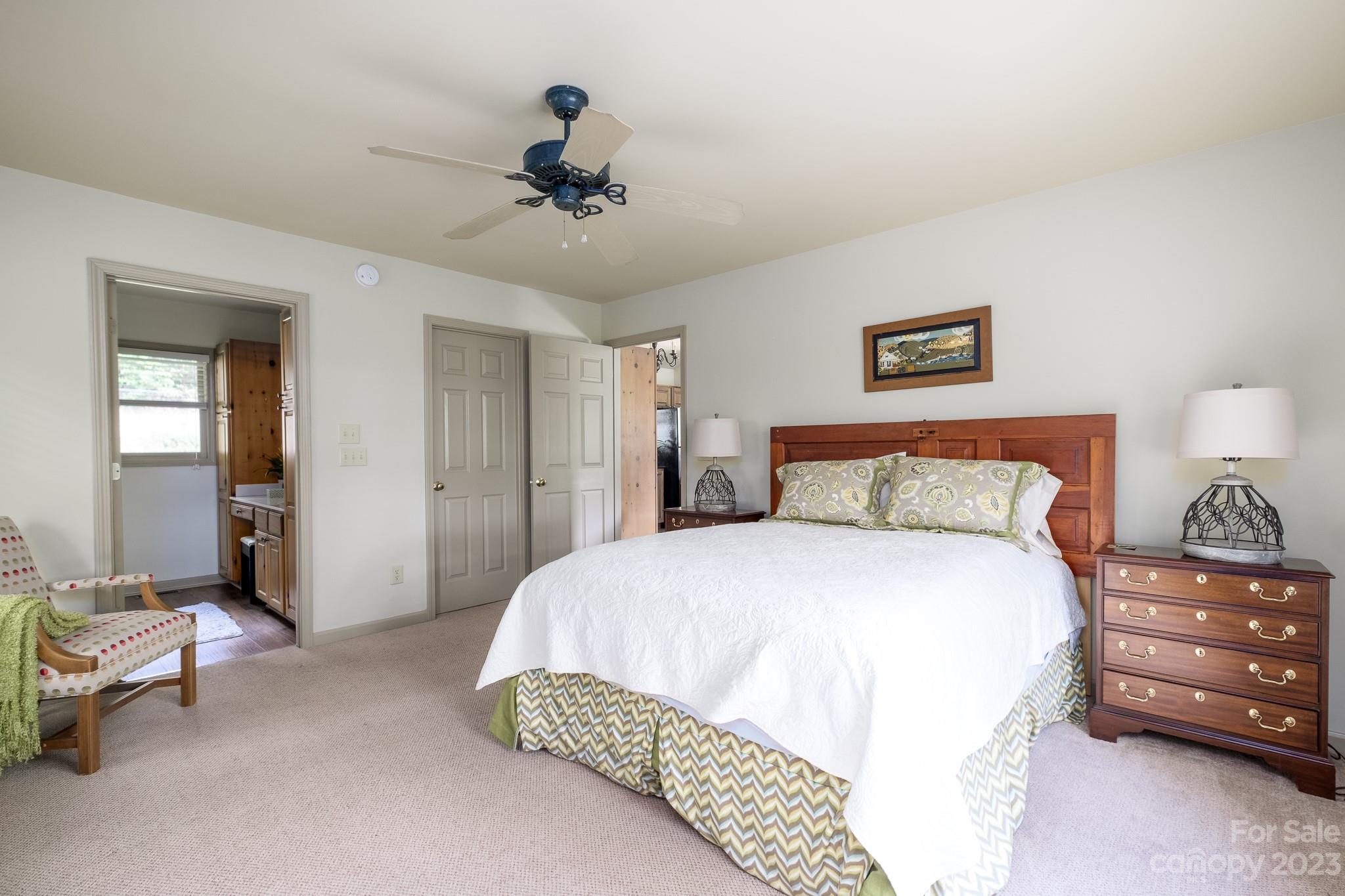 122 Columbine Way Cleveland, SC 29635 - Photo 13 of 28 a spacious bedroom with a bed and a chandelier