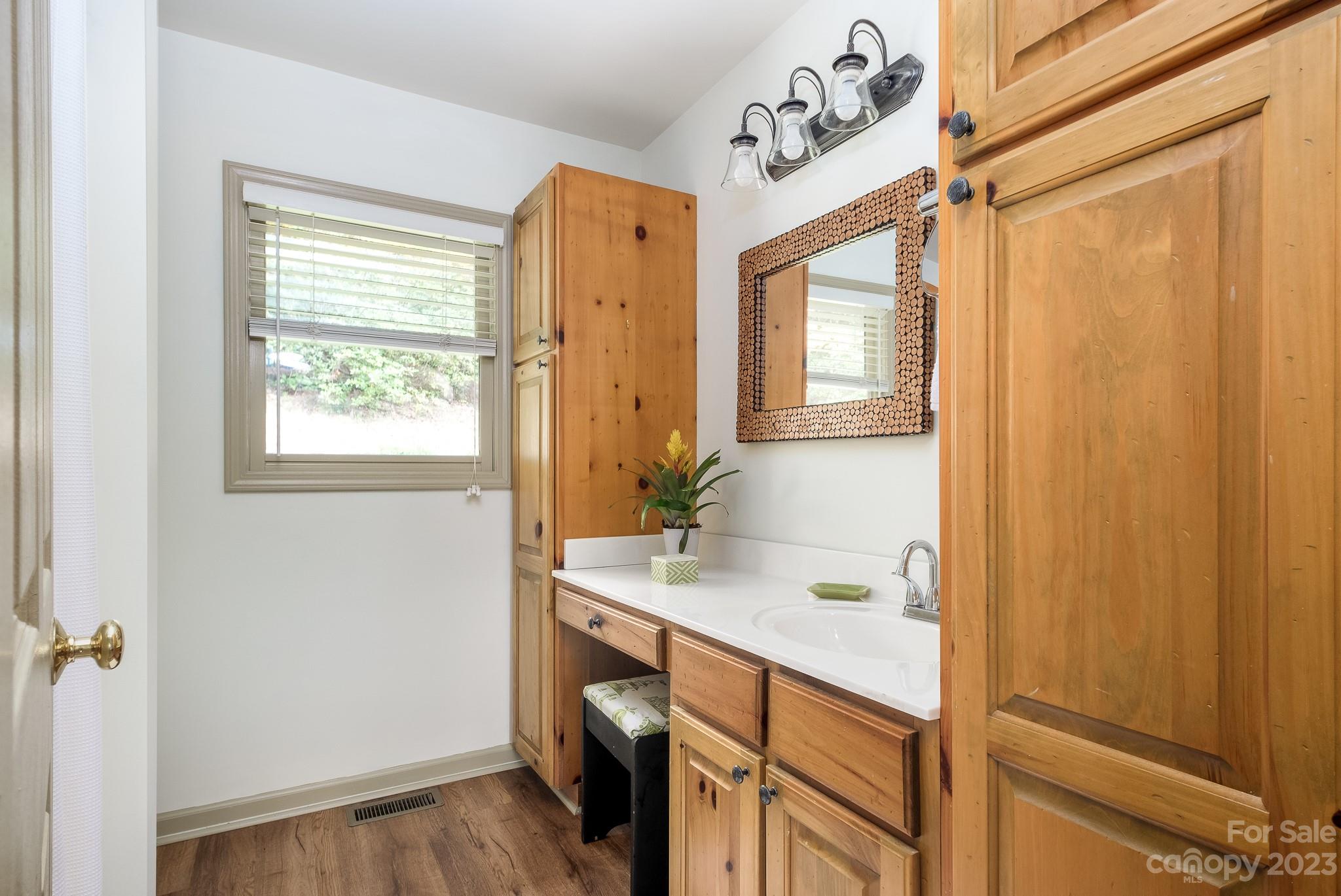 122 Columbine Way Cleveland, SC 29635 - Photo 14 of 28 a bathroom with a sink a mirror and a window