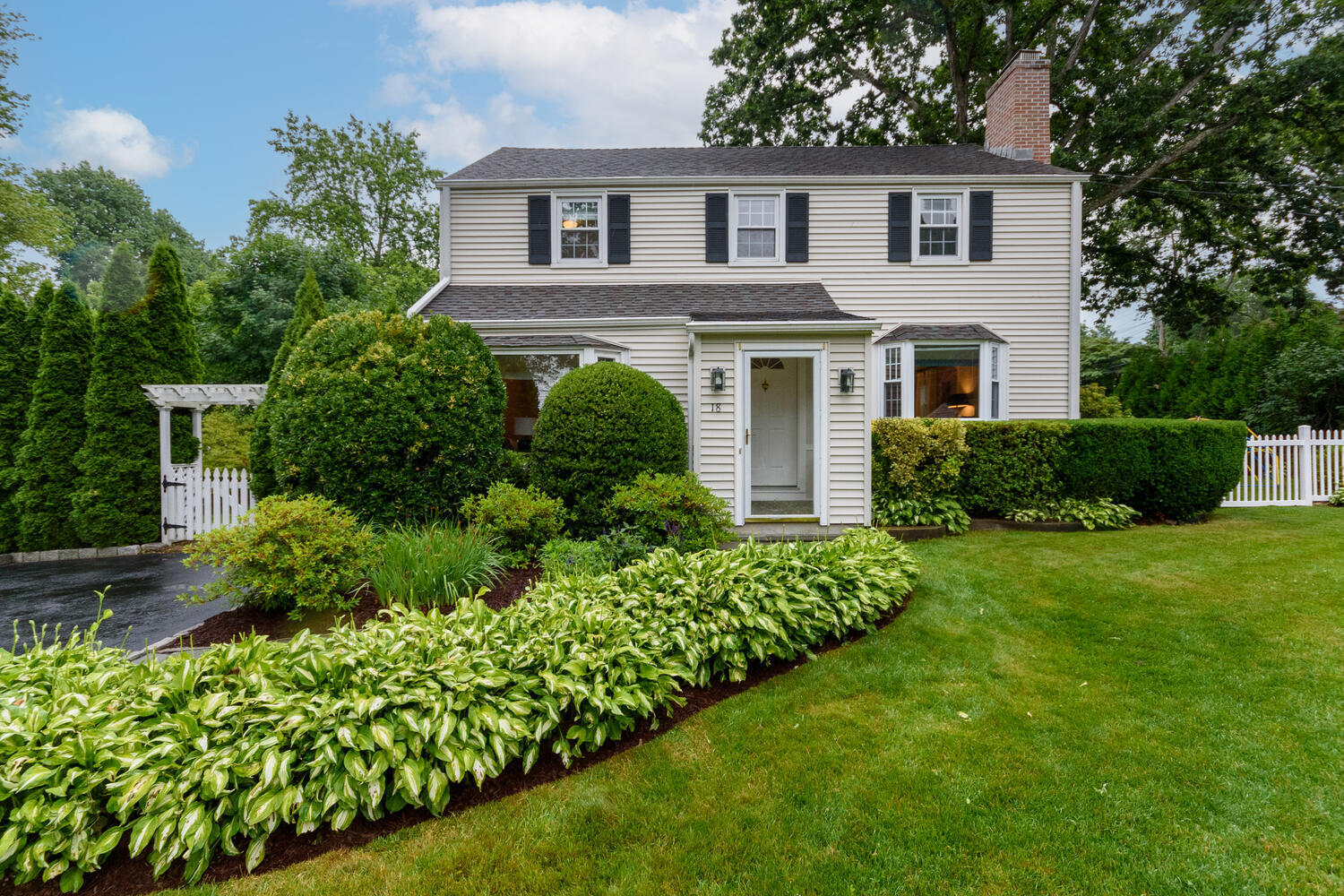 18 Patton Drive Darien, CT 06820 - Photo 1 of 35 a front view of a house with a garden