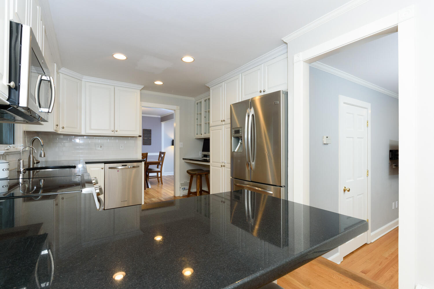 18 Patton Drive Darien, CT 06820 - Photo 12 of 35 a kitchen with stainless steel appliances granite countertop a refrigerator a stove and a sink with wooden floor