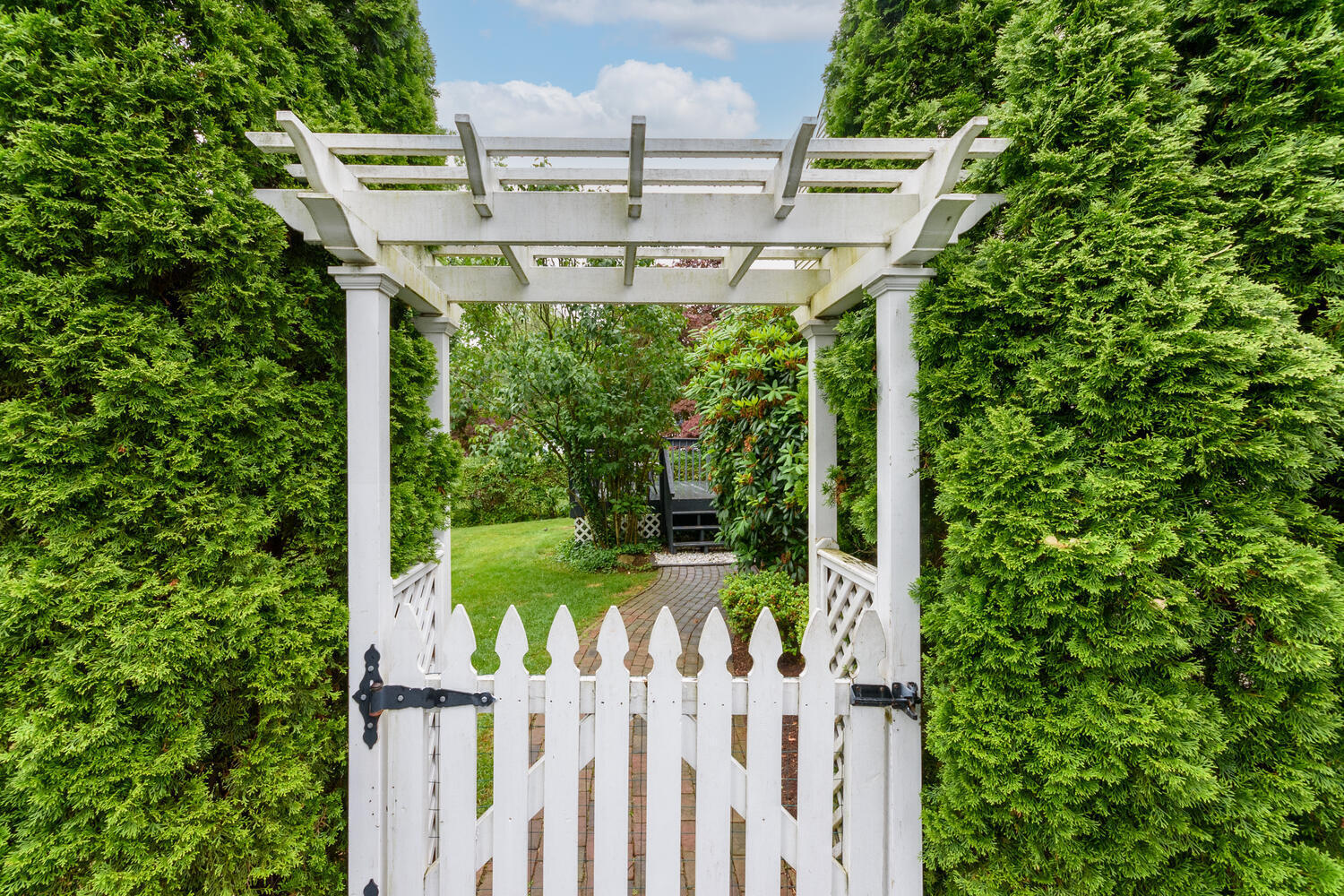18 Patton Drive Darien, CT 06820 - Photo 26 of 35 a view of a yard with plants and wooden fence