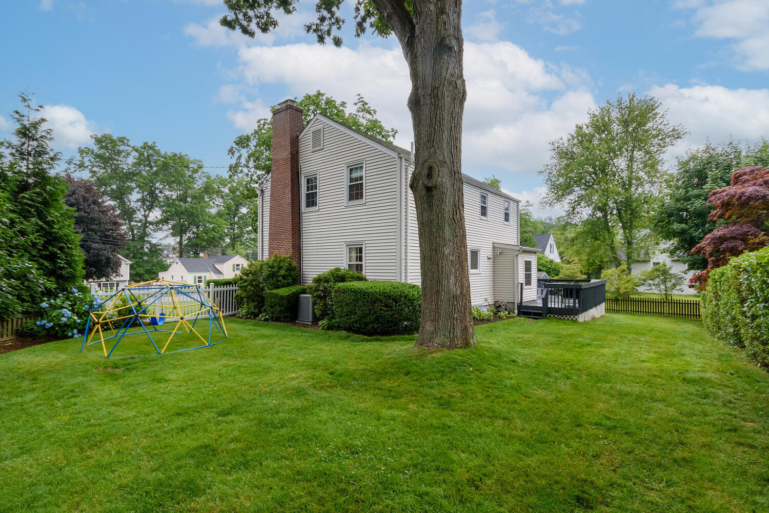 18 Patton Drive Darien, CT 06820 - Photo 31 of 35 a view of a house with backyard sitting area and garden