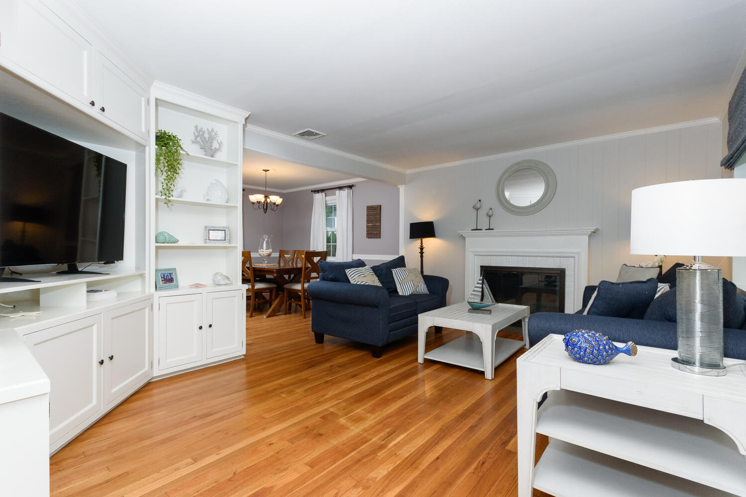 18 Patton Drive Darien, CT 06820 - Photo 6 of 35 a living room with furniture a flat screen tv and a fireplace