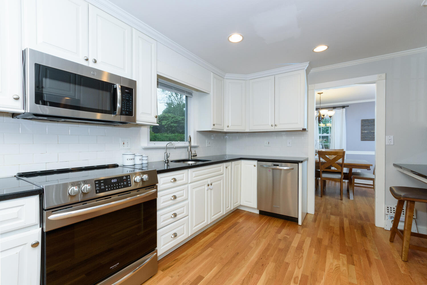 18 Patton Drive Darien, CT 06820 - Photo 9 of 35 a kitchen with stainless steel appliances a stove microwave and cabinets