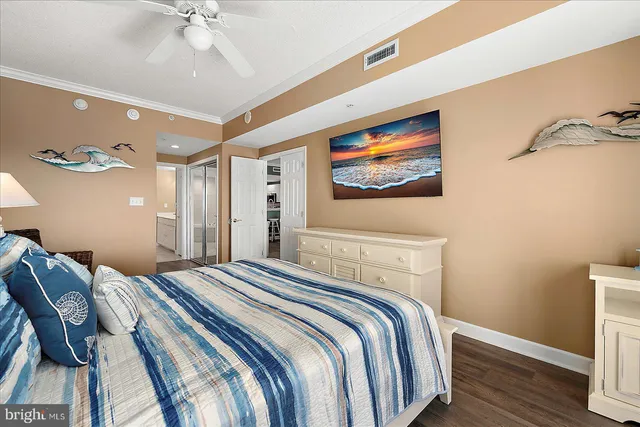 a bedroom with a large bed and a wooden floor