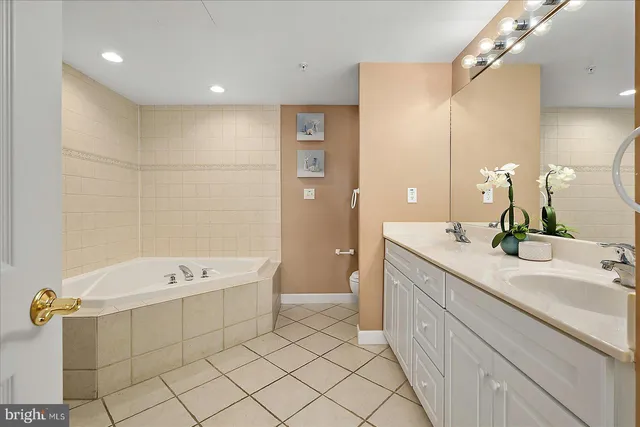 a bedroom with a bed and a large mirror