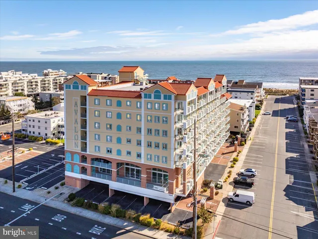 a living room with furniture fireplace and a large window