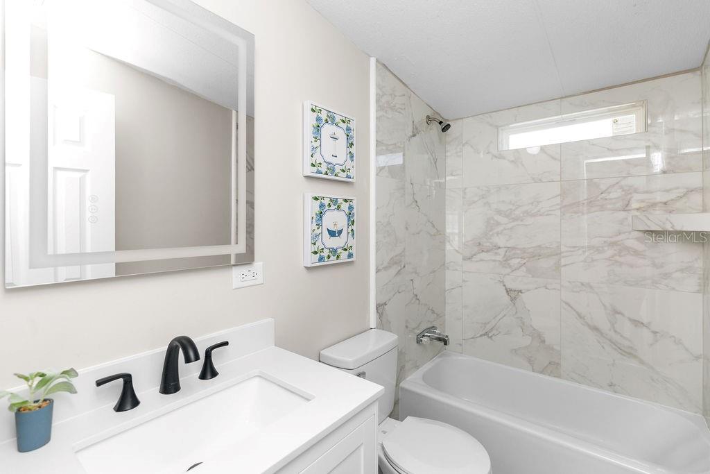 18137 Hollister Road Orlando, FL 32820 - Photo 17 of 27 a bathroom with a sink toilet and shower