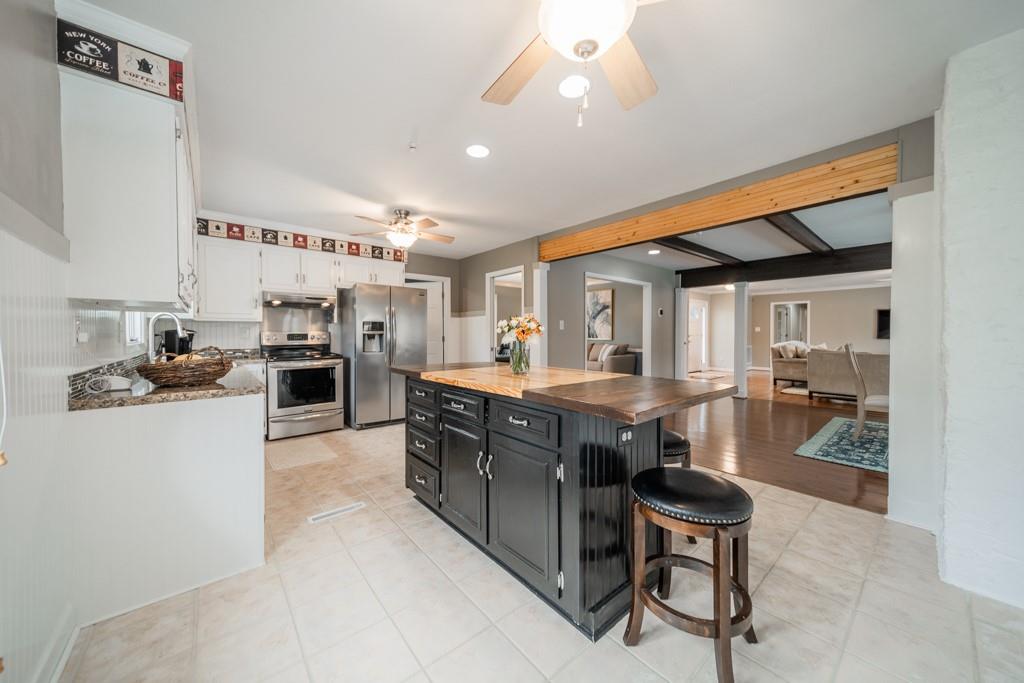5111 Rounding Run Road Charlotte, NC 28277 - Photo 12 of 35 a kitchen with stainless steel appliances granite countertop a sink a stove and a refrigerator