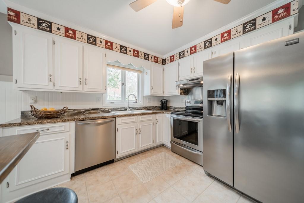 5111 Rounding Run Road Charlotte, NC 28277 - Photo 14 of 35 a kitchen with granite countertop a white cabinets and stainless steel appliances
