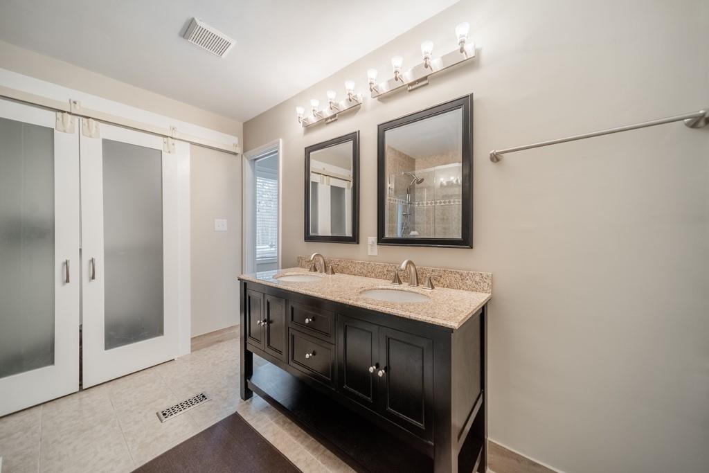 5111 Rounding Run Road Charlotte, NC 28277 - Photo 19 of 35 a bathroom with a double vanity sink and a mirror